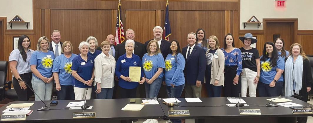 Members of the Burnet County Child Welfare Board, Courtappointed Special Advocates (CASA) for the Highland Lakes and Hill Country Children's Advocacy Center are pictured here April 9 with Burnet County commissioners and county officials (back row) after the government body proclaimed April Child Abuse Awareness Month. Contributed photo