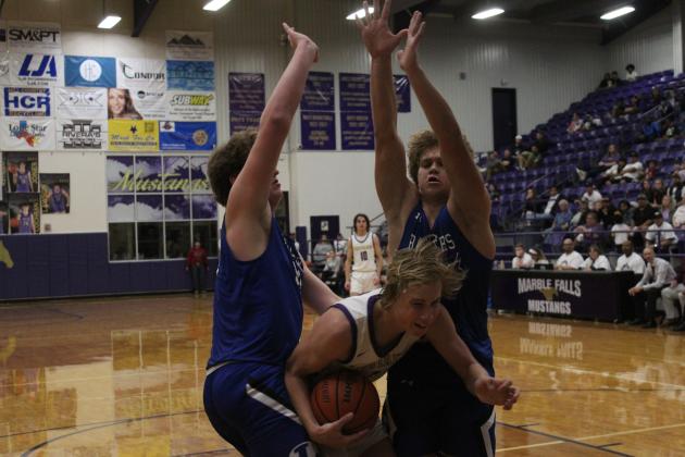 Marble Falls senior forward Davis Dreisbach is sandwiched between two Lampasas Badgers, who refuse to give him a lane to the basket.