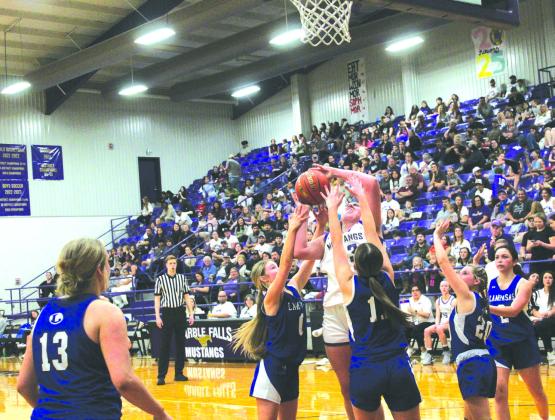Marble Falls senior center Lexie Edwards draws a crowd on a crucial two-foot jump shot to keep the Lady Mustangs even with Lampasas Jan. 30.