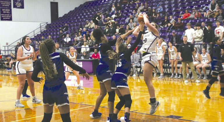 Marble Falls junior forward Bethany Fry ends a drive to the hoop with a turnaround jumper to help the Lady Mustangs record the district victory. Photos by Jennifer Fierro/TexasChalkTalk.com