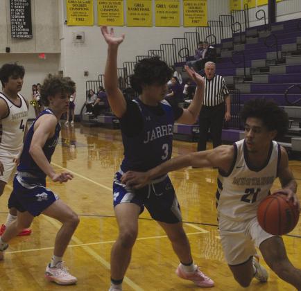 Marble Falls junior guard Tidus Willie is bumped as he drives to the basket during the first half against Jarrell.