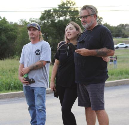 Connie Swinney/The Highlander From left, Daniel Gatehouse, his sister Karen Bennett and father Rich Gatehouse arrived on the scene Oct. 4, as fire ripped through the two-story strip mall where their businesses were located on the Avenue H side of the building in Marble Falls.