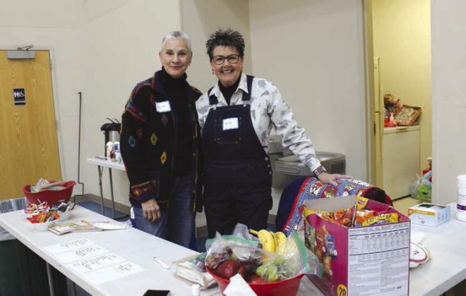 Lorinda Peters (left) and DeDe Langley kept the snack booth fully stocked Jan. 15 for attendees of the Warming Center in Marble Falls.