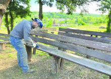LCRA employee Eric Roth sanded a bench at Grenwelge Park in Llano during LCRA's Steps Forward Day on April 12. Contributed photos