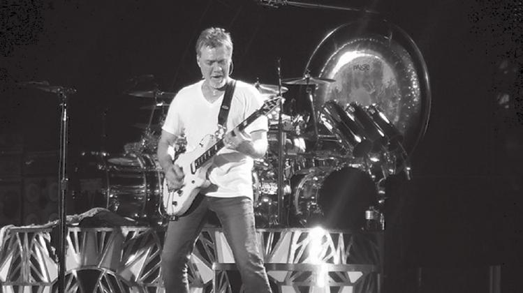 Guitarist Eddie Van Halen, front, performs his classic instrumental “Eruption” during an August 2015 Van Halen concert in Dallas while brother Alex Van Halen plays drums in the background. The music world is mourning after Eddie died Tuesday, Oct. 6, at the age of 65. Lew K. Cohn/The Highlander
