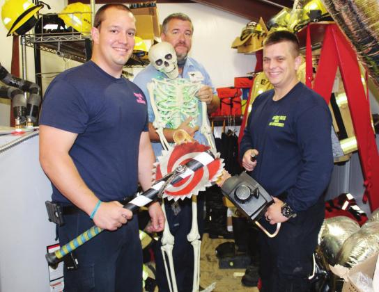 Marble Falls VFD crew member, from left, Firefighter Bobby Amick, Capt. Thomas Jacobs and Firefighter Justin Park had some fun with props and costumes in preparation of the department’s annual haunted house on Friday, Oct. 30 and Saturday, Oct. 31 at the station, 606 Avenue U. Connie Swinney/The Highlander