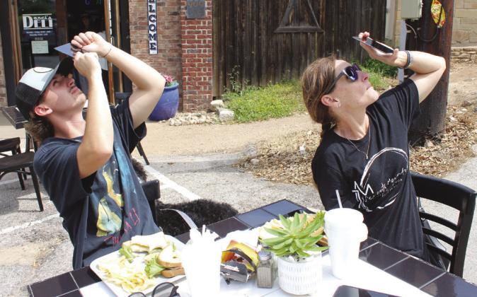 Alden Littlefield and his mother Susan Littlefield viewed the start of the total solar eclipse April 8 through welders hood glass, while enjoying lunch at Darci's Deli in Marble Falls.