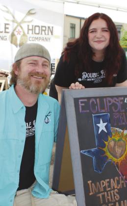 Emma Maxwell and Trenton Gillen of Double Horn Brewing Company were among vendors April 8 at the Marble Falls downtown Eclipse Block Party.