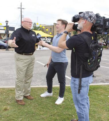 Marble Falls Mayor Dave Rhodes (left) granted an Austin TV station an interview. Pictured with him are TV reporter Will DuPree and videographer Chris Nelson.