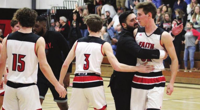 Nathan Hendrix/The Highlander Flames Head Coach Zakk Revelle embraces senior Gus Henry after a basket in the fourth quarter that forced a St. Paul timeout. The Flames play in the TAPPS 2A Regional final on Saturday in Brenham.
