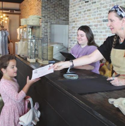 Participating merchants in the Egg Scavenger Hunt included Redid’s Dee Johnson, who offered vouchers to youngsters as proof of their search for prizes.