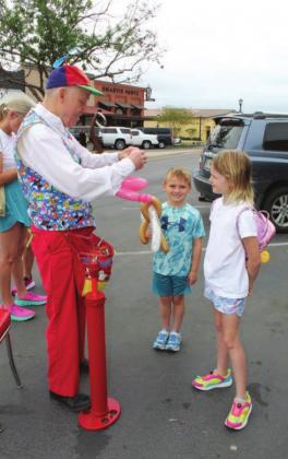 Siblings Sloane, 8, and Sutton, 6, Jackson were delighted by the balloon “artist”, staged in downtown Marble Falls as part of the egg-stravaganza of the Egg Scavenger Hunt on Friday, April 15.