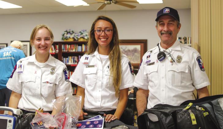 EMTs Hannah Zalenski, Maegan Macharg and Alex Dunavant displayed their wares while available to answer questions during the Senior Health Fair Oct. 6. Photos by Martelle Luedecke/Luedecke Photography