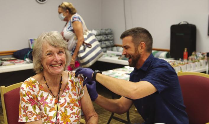 Russell Meek from Atkins Pharmacy administered a seasonal vaccination to Carole Coburn during the Senior Health Fair Oct 6.
