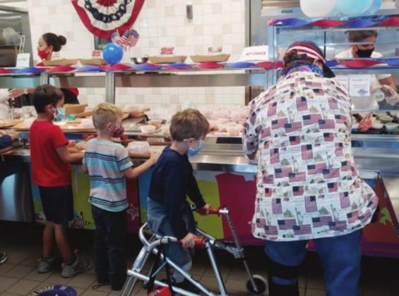Left: Child nutrition departments across the district did their part to participate in the festivities on Veterans Day, Wednesday, Nov. 11. Cafeterias and lunch lines were decorated with red, white and blue, and students were served all-American meals.