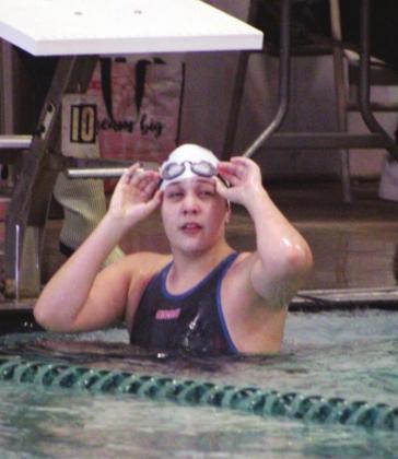 Senior swimmer Taylor Ashbaugh peeks at the scoreboard after finishing the 50 yard freestyle. She won her heat and finished 11th overall in the event. Nathan Hendrix/ The Highlander