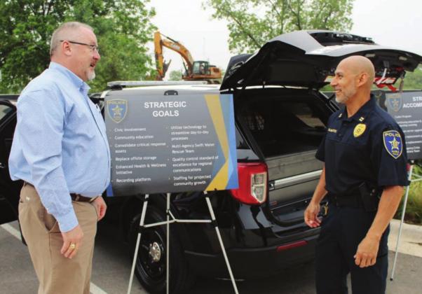 Above: Marble Falls Police Assistant Chief Glen Hanson conferred with Capt. Robert Talamantes at the start of a facilities and infrastructure tour on May 11 by council members. Photos by Connie Swinney/The Highlander