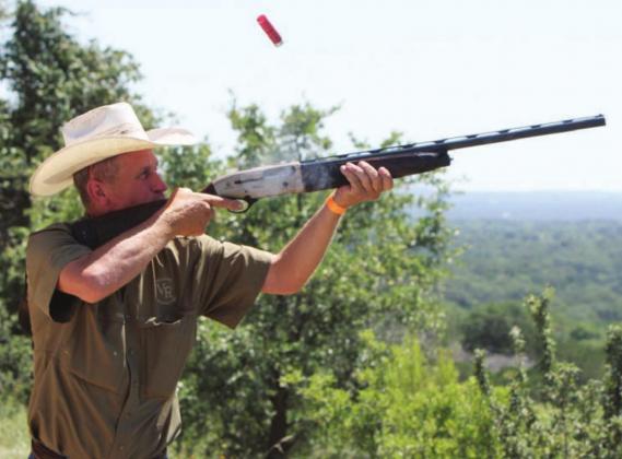 Todd Gibson sends a shell flying as he hits a target during the annual Shoot for Coop clay shooting fundraiser held Saturday, June 13, at the Despain Ranch. The event raises money for scholarships to college and Camp Peniel for area youth in memory of the late Cooper Despain. Kelly McDuffie/Contributing Photographer