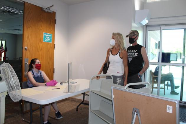 At midnight, June 30, a Marble Falls city order goes into effect directing businesses and other public spaces to turn away customers who do not wear masks to try to reduce the number of COVID-19 cases. Pictured here are patrons browsing recently at the Marble Falls Public Library.