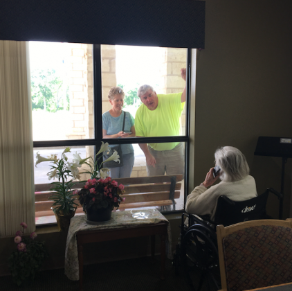 A couple visited recently with a loved one who is in the Granite Mesa Nursing Home in Marble Falls. The state is now allowing more leeway for one-one-one visits with health screening guidelines. File photo