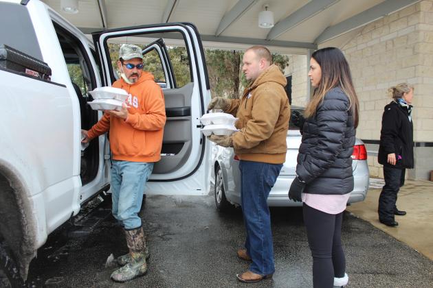 Highland Lakes Crisis Network volunteers Kevin (center) and Rachel Naumann and Rob Borchardt launched a food distribution effort for families in need. The group will continue serving food at 3 p.m. Friday, Feb. 19 at Marble Falls First United Methodist Church and at the Granite Shoals Police Department.