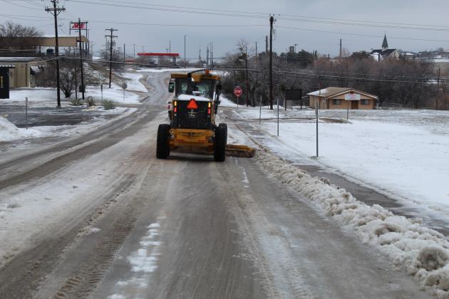Crews from the city of Marble Falls worked much of the day Feb. 17, clearing streets including a swath of Avenue N (pictured here) which was packed with snow and ice after several days of sub-freezing temperatures. Connie Swinney/The Highlander