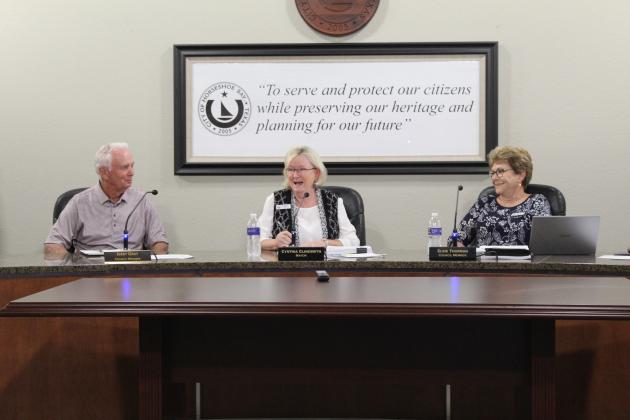 During a moment of levity, Horseshoe Bay Mayor Cynthia Clinesmith, center, laughs after newly appointed Councilmember Jerry Gray, left, made seconding a motion to name Elsie Thurman, right, the new mayor pro tem his first official act upon his return to the council dais. Gray was appointed Tuesday to serve the remainder of Kent Graham's term and was sworn into office prior to taking his seat. Lew K. Cohn/The Highlander 