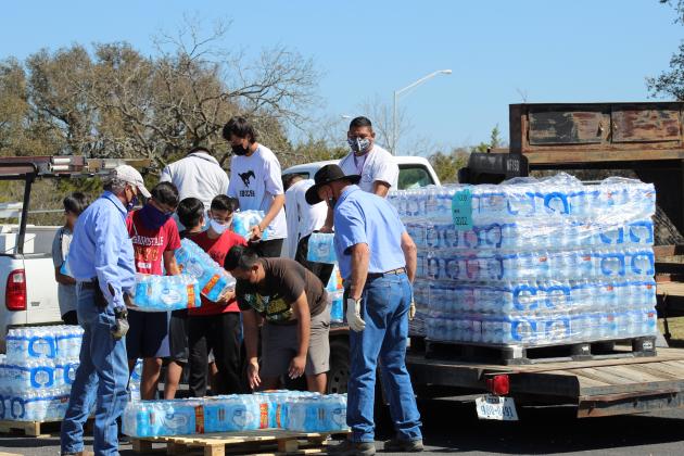 During a post storm event in February, Marble Falls ISD students assisted in water distribution with the requirement of wearing facecoverings. The district voted May 11 to rescind the requirement and make it optional.  File photo