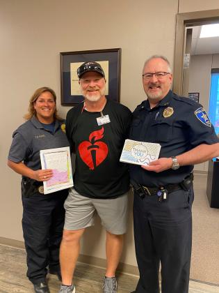 Marble Falls Elementary PE instructor Michael Lehman, center, brought thank you letters from his wife's (MFE first grade teacher Ashlea Lehman) class to Marble Falls Police Capt. Trisha Ratliff and Assistant Chief Glenn Hanson. Police personnel also visited the class to thank them in person.