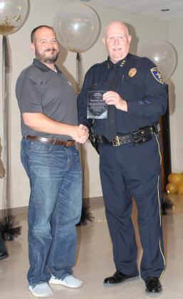 Chief Mark Whitacre was given a civic duty award June 25 for his service to the city of Marble Falls by Assistant City Manager Caleb Kraenzel. Connie Swinney/The Highlander