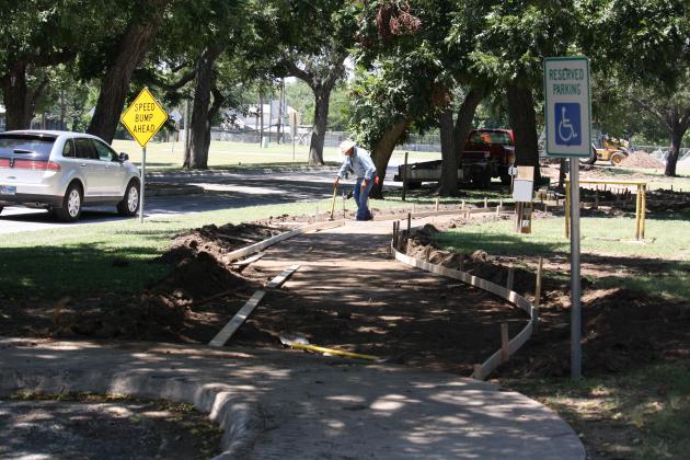 The city invested several thousand dollars in sidewalk work in Johnson Park and raised concerns about vehicles and other equipment parked on the amenity during festivals and events.