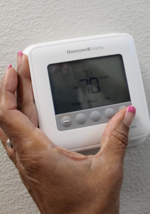Set your programmable thermostat to a higher temperature. This will keep your air conditioner from blowing cold air at full speed while you’re gone. File photo