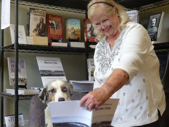Museum volunteer Nancy Ebeling and her dog Joe look over A Pictorial History of Marble Falls. The book will now be reprinted with assistance from The Highlander newspaper and the city of Marble Falls. Contributed