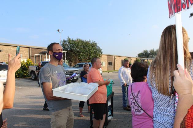 Marble Falls ISD Board Trustee Alex Payson (at left) and Board President Kevin Naumann (right) - both of whom voted in favor of the mask mandated - attended the event.