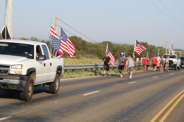 The group of about a dozen Patriot Day marchers traveled in the outside eastbound lane on U.S. 281 with escorts including a unit from Granite Shoals Police Department.