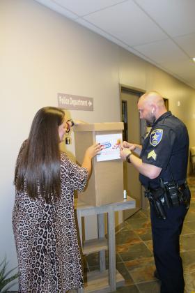 Marble Falls Police Sgt. Justin Boucher and Administrative Assistant Amanda Langley prepped a bin for the drug take back program in April. Another opportunity to drop off unused or expired medication will occur on Saturday, Oct. 23. File photo