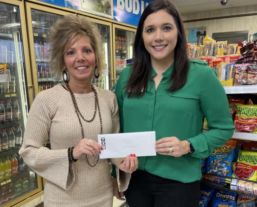 Sherry Capehart, executive administrative assistant at TXB, presented the check to CASA for the Highland Lakes Executive Director Brittany Grubbs.