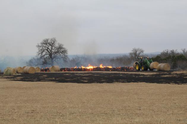 By about 10 a.m. Feb. 23 workers on the property along RR 1431 between Granite Shoals and Marble Falls had relocated a number of large hay bales as dozens more went up in flames.