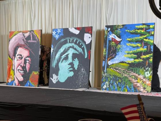 The entertainment during Texas Governor Greg Abbott's visit to Burnet County included a highly charged and creative art demonstration by Paint Jam which produced patriotic images to be auctioned off.