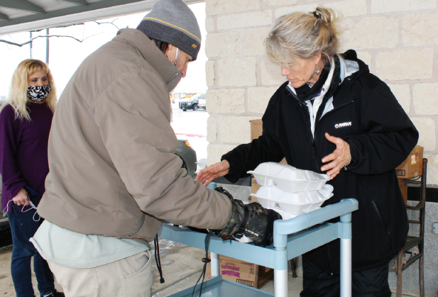HLCN volunteers Susan Rader and First Baptist Church Pastor Ross Chandler assisted with food distribution during the 2021 winter storm. File photo