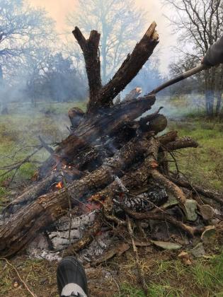 As the county judge lifts the ban, Burnet County residents are taking the opportunity to burn brush such as this burn pile in Timber Ridge. File photo