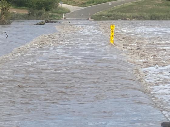 The Llano River on CR 102 in Llano County swelled over the roadway, sending a torrent of water into the Highland Lakes. Despite the downpour, Central Texas Groundwater Conservation District officials will maintain restrictions on permitted well water use. Contributed/Llano County Office of Emergency Management