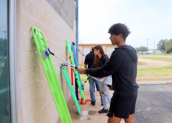 William Guzman and Celena Gonzalez washed the back boards for the ambulances Feb. 16, while volunteering on Rick Edwards Day of Service. Find more photos on Pages 10 and 11. Photos by Martelle Luedecke/Luedecke Photography