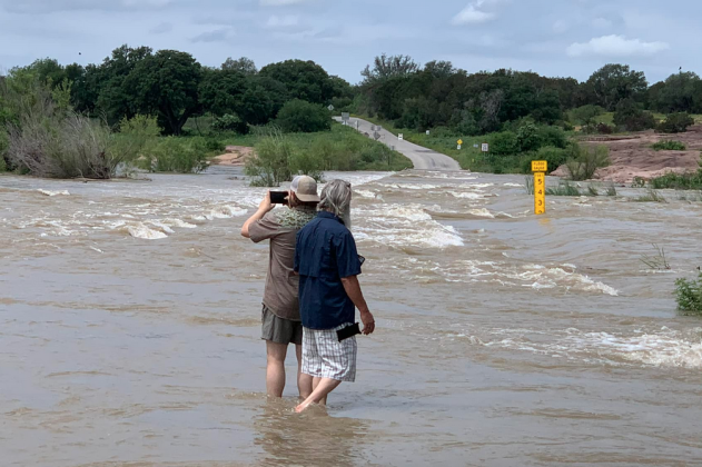 Marty Mangum shared this image of folks on Slab Road on Sunday, May 5, providing a hint of the water overflowing the crossing and making its way downstream through Lake LBJ, Marble Falls and Travis.