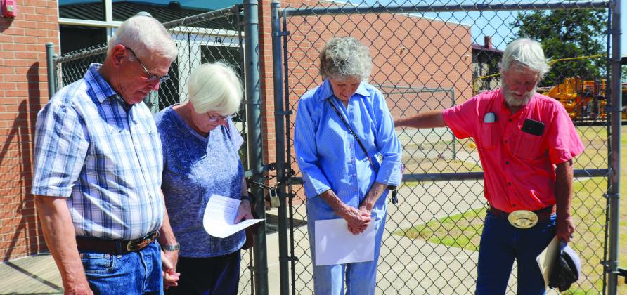 Warren and Donna Heffington, Jen Graves, Keith Smith praying for protection over the playground activities at Marble Falls Elementary School Tuesday afternoon.