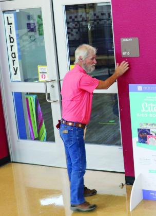 Keith Smith of the Highland Lakes Crisis Network prays over the library within the Marble Falls Elementary School Tuesday, Aug. 15, the day prior to the start of school..