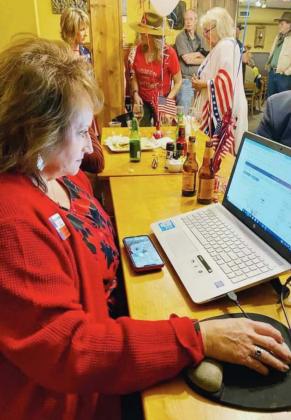 Dozens of supporters of the Republican Party hosted an election night watch party at Trailblazer Grille in Burnet. Burnet County Republican Chairwoman Kara Chasteen (left) monitored results on Nov. 3. Contributed photos