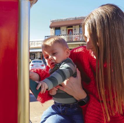 Seven-month-old Colby Jones, with the help of his mom Kristi, mailed his first letter to Santa Sunday, Dec. 17, on the Burnet County Courthouse square. Find some of the letters sent to the North Pole from local children in the B-section. Martelle Luedecke/Luedecke Photography