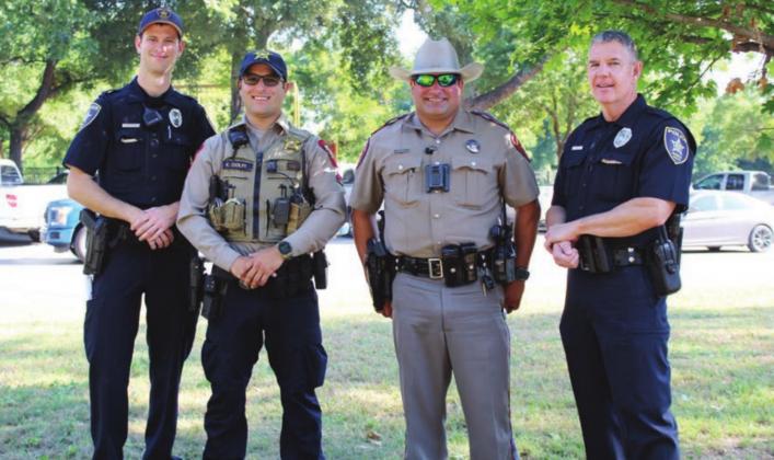 Above: Law enforcement from area agencies provided security for the protest event in Marble Falls on June 13. Pictured, from left, are: Marble Falls Police Officer Connor Du Coty; Burnet County Sherff’s Office Deputy Kyle Ciolfi; Texas Department of Public Safety Trooper Steven Petrick; and Marble Falls Police Officer Max Johnson.