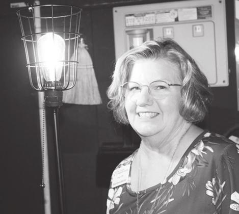 Hill Country Community Theatre Executive Director Patty Gosselin stands near the “ghost lamp” lighted at the theater backstage to honor the late HCCT Executive Director Mike Rademaekers.